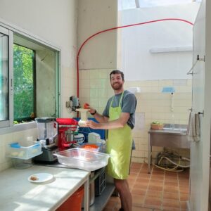 Busy in the kitchen helping prepare lunch for guests and volunteers